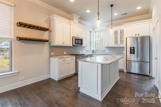 a kitchen with a sink refrigerator and microwave