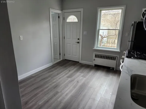 a view of a livingroom with furniture window and wooden floor