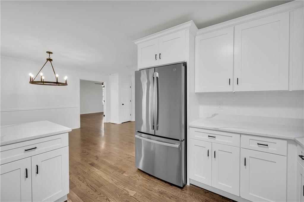 2941 Lake Hollow Road Gainesville, GA 30501 - Photo 16 of 53 a kitchen with white cabinets and stainless steel appliances