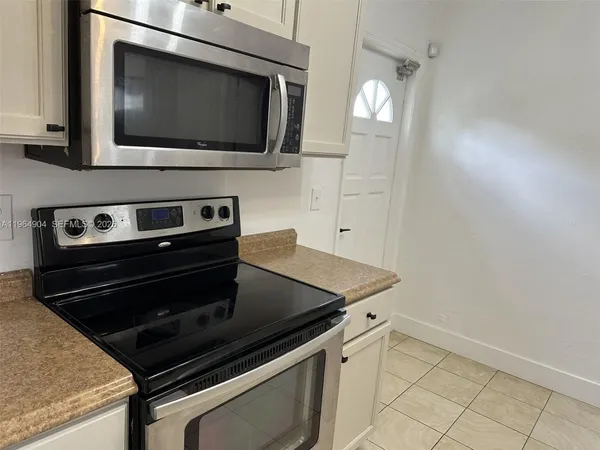 a kitchen with a stove and a microwave