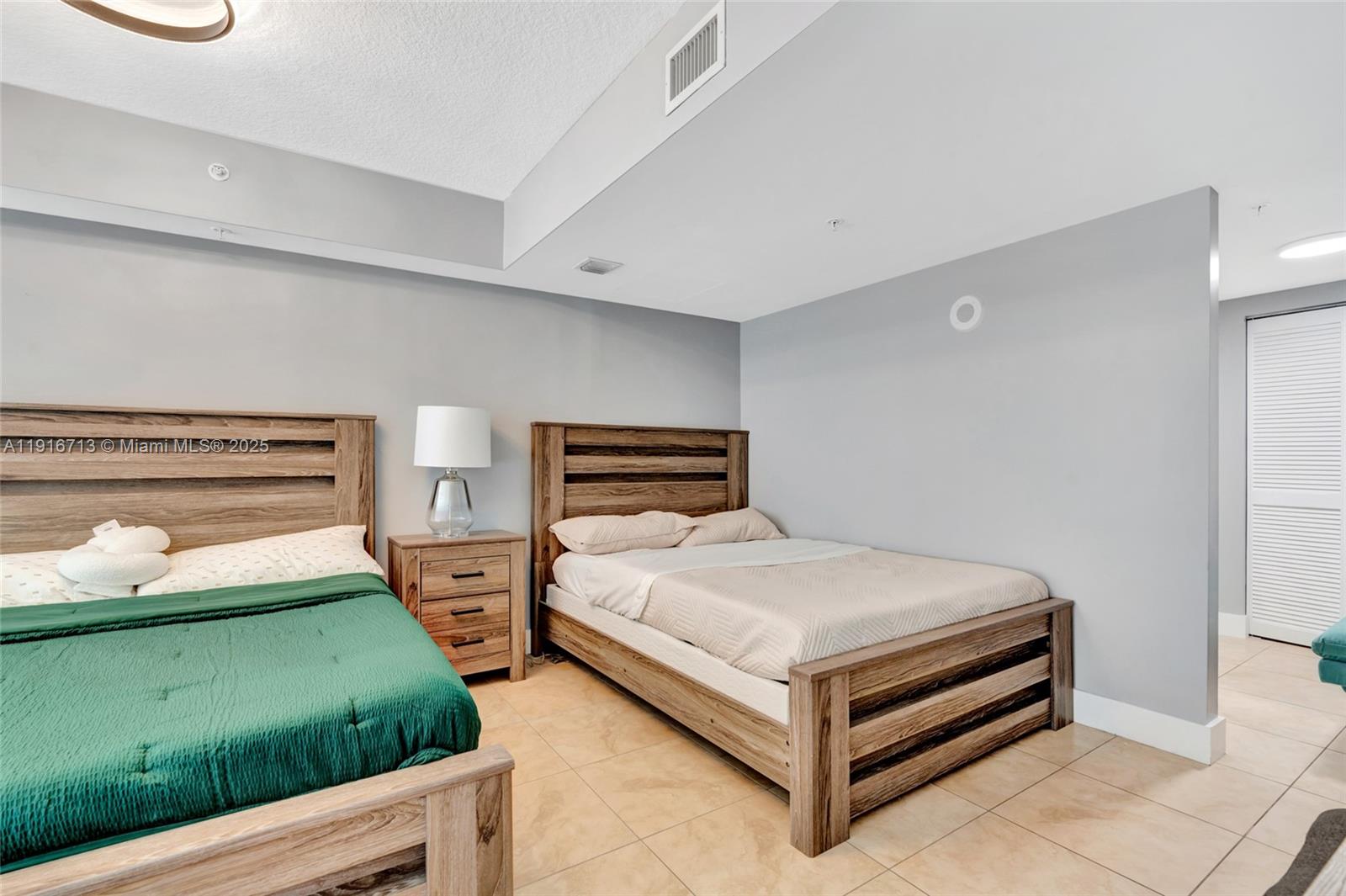 41 Southeast 5th Street, Unit 1212 Miami, FL 33131 - Photo 11 of 37 a bedroom with a bed and two night stand