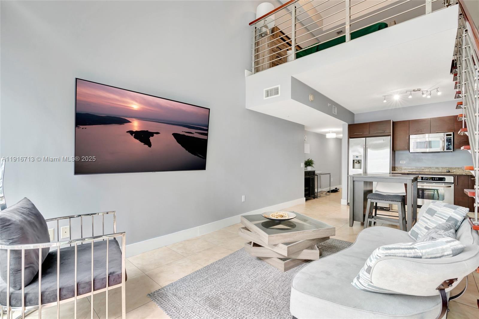 41 Southeast 5th Street, Unit 1212 Miami, FL 33131 - Photo 12 of 37 a living room with furniture and a wall painting