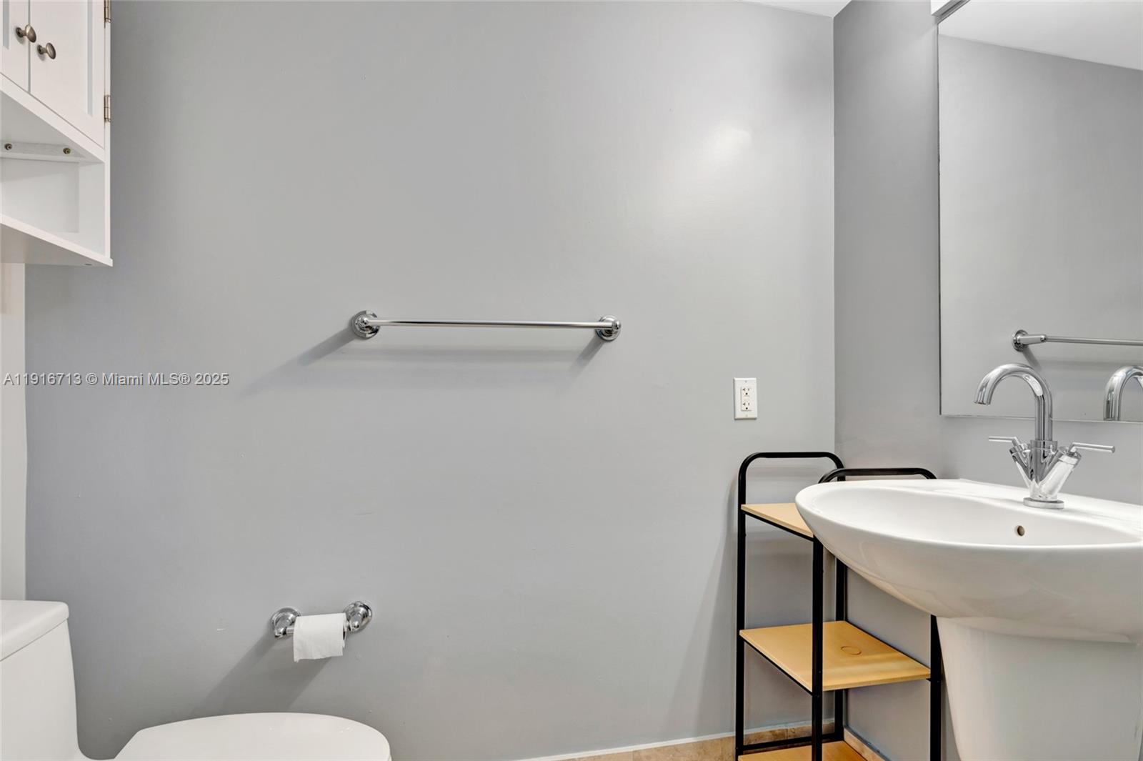 41 Southeast 5th Street, Unit 1212 Miami, FL 33131 - Photo 18 of 37 a bathroom with a sink mirror and toilet