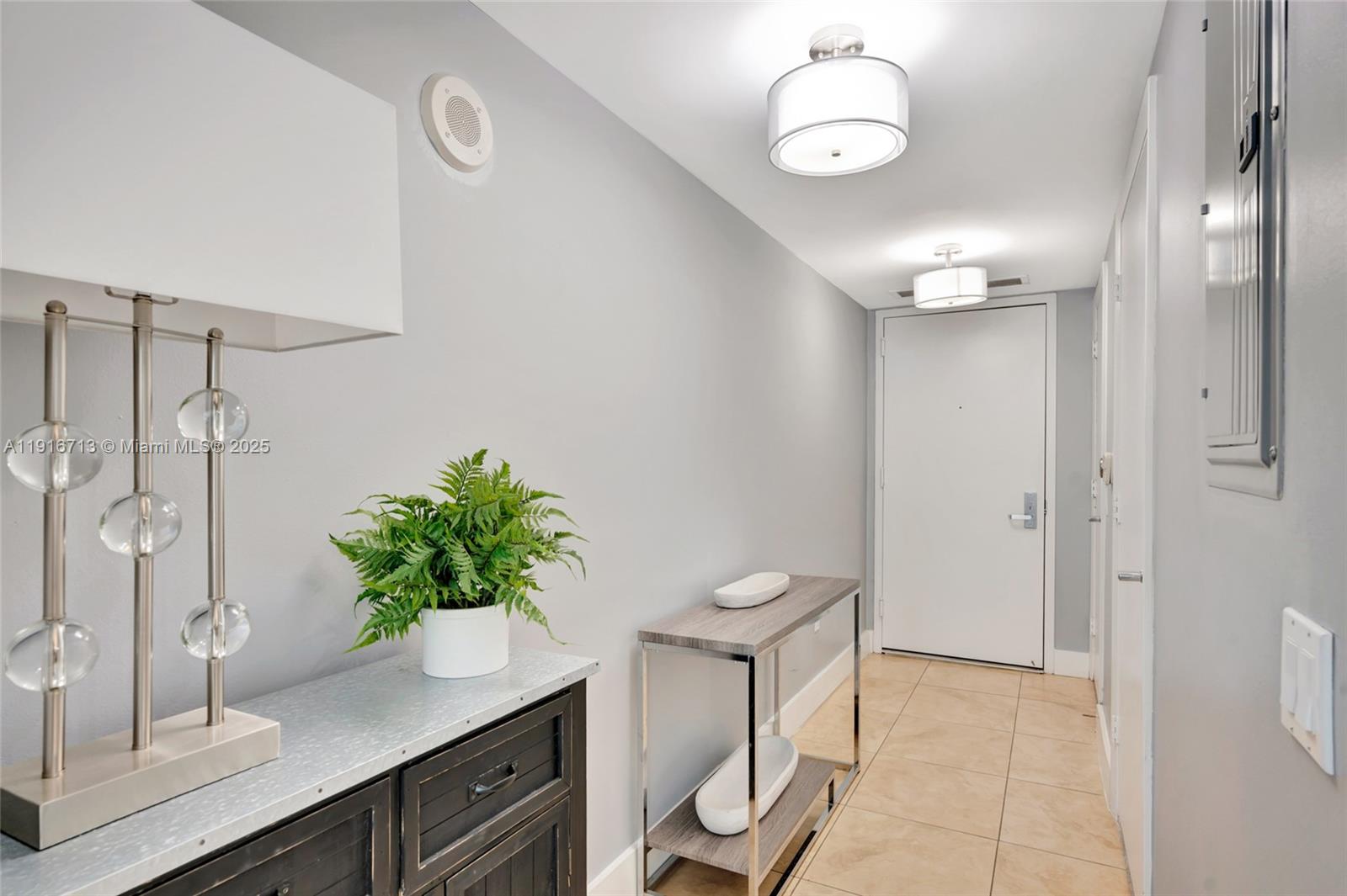 41 Southeast 5th Street, Unit 1212 Miami, FL 33131 - Photo 19 of 37 a view of a bathroom with a potted plant on the counter and sink