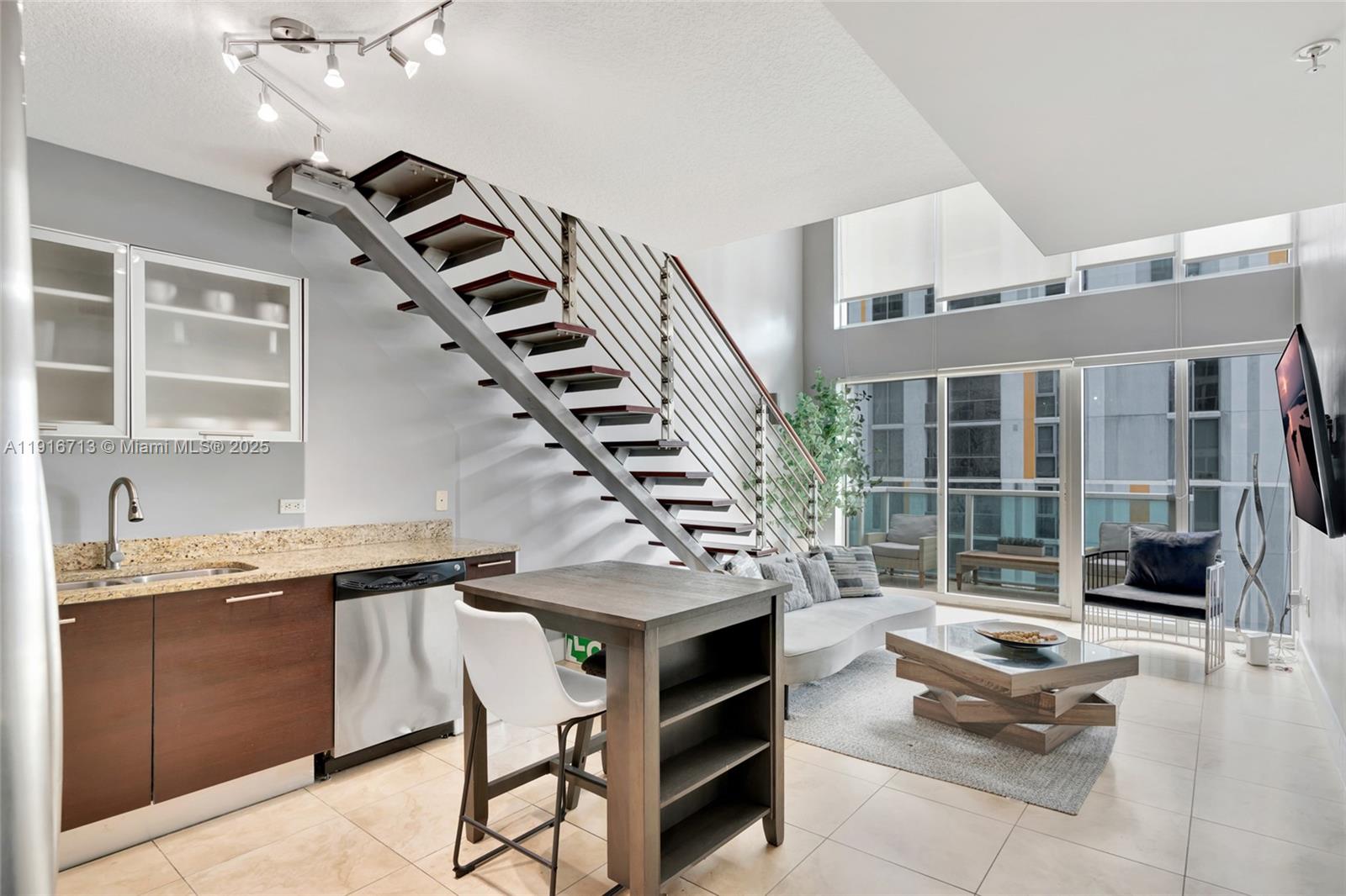 41 Southeast 5th Street, Unit 1212 Miami, FL 33131 - Photo 3 of 37 a living room with granite countertop furniture and a potted plant