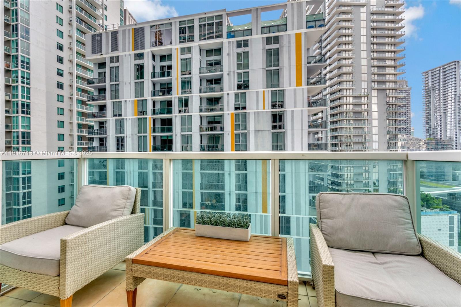 41 Southeast 5th Street, Unit 1212 Miami, FL 33131 - Photo 4 of 37 a view of a balcony with two chairs and a large window