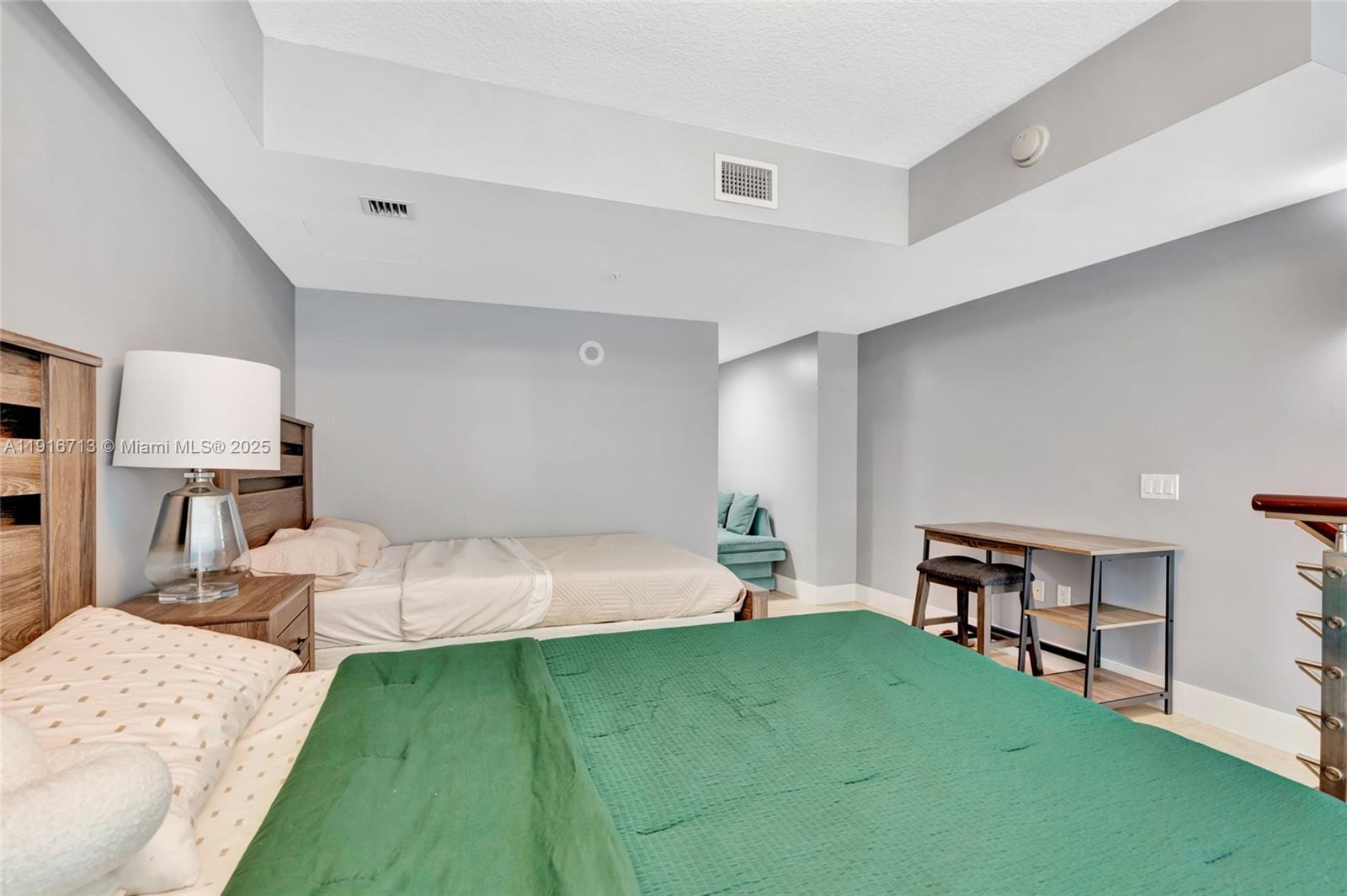 41 Southeast 5th Street, Unit 1212 Miami, FL 33131 - Photo 9 of 37 a bed room with a bed and a chair