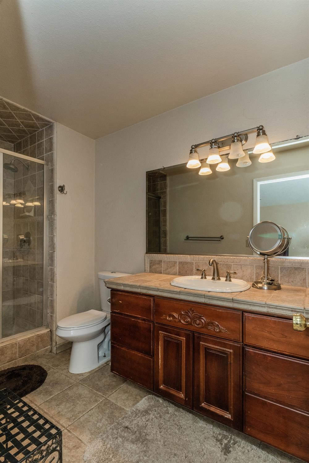3440 Olive Street Selma, CA 93662 - Photo 13 of 21 a bathroom with a double vanity sink and a toilet