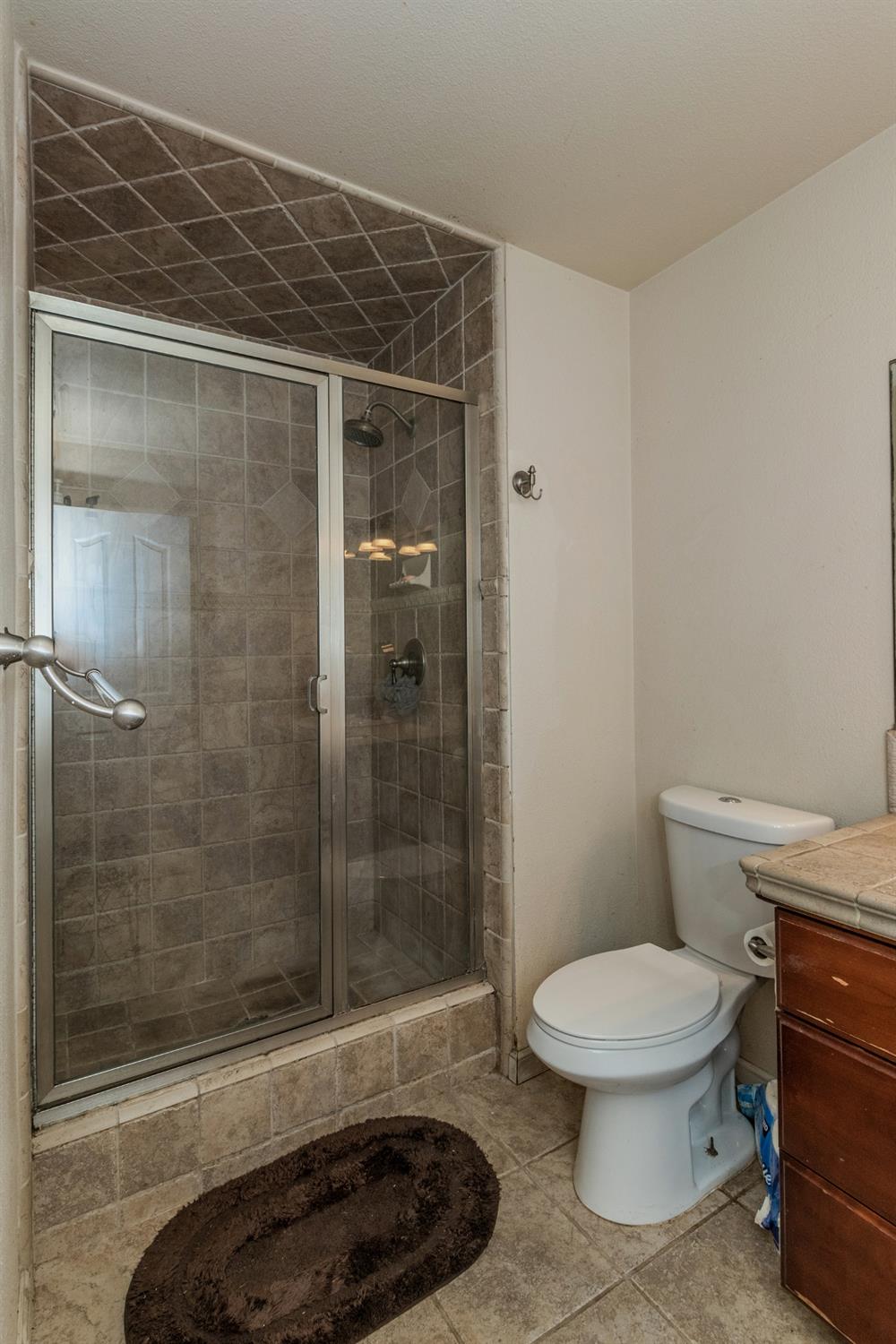 3440 Olive Street Selma, CA 93662 - Photo 14 of 21 a bathroom with a toilet and a shower