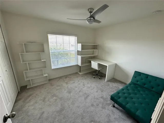 a view of workspace with furniture and windows