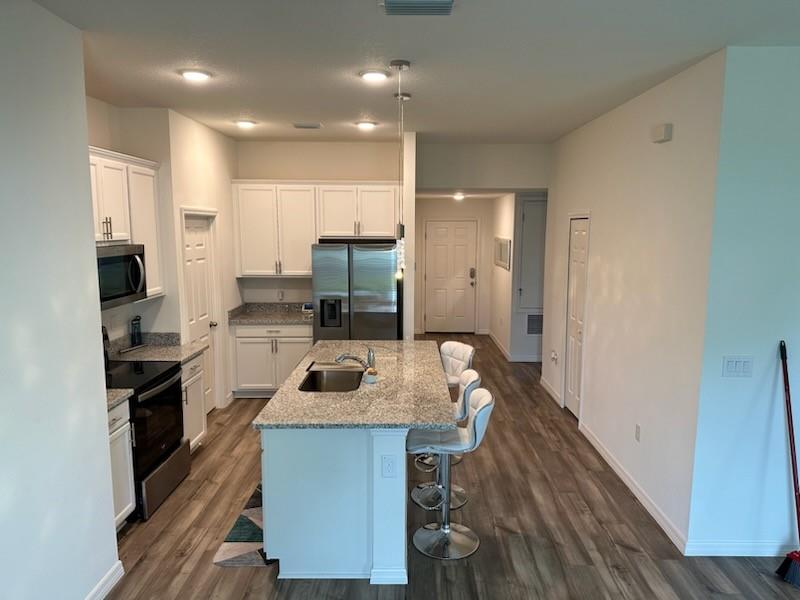 1099 Dania Circle Palm Bay, FL 32905 - Photo 3 of 17 a kitchen with a sink appliances and cabinets