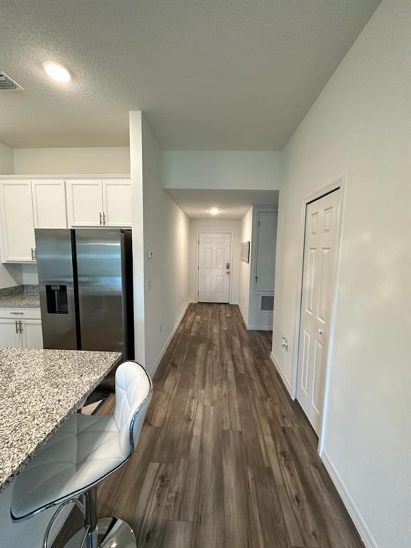 1099 Dania Circle Palm Bay, FL 32905 - Photo 4 of 17 a kitchen with granite countertop white cabinets a refrigerator and a sink