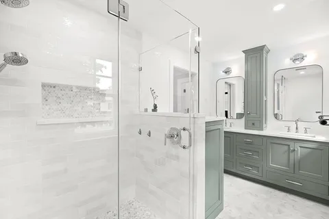 a bathroom with a double vanity sink mirror and shower