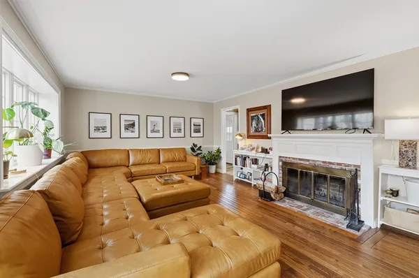 a living room with furniture a flat screen tv and a fireplace