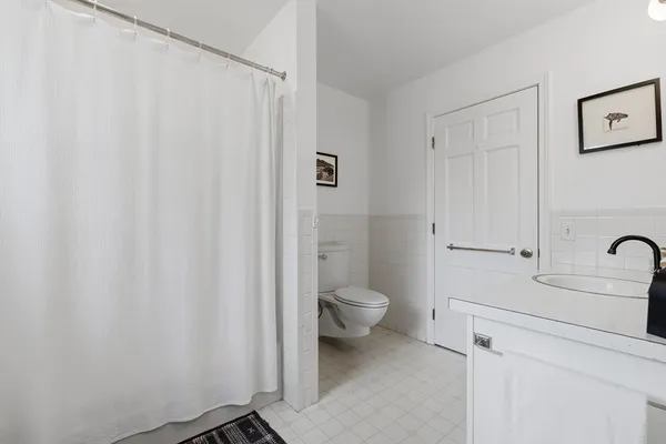 a bathroom with a toilet a sink and shower