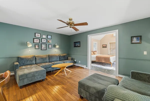 a living room with furniture and a wooden floor