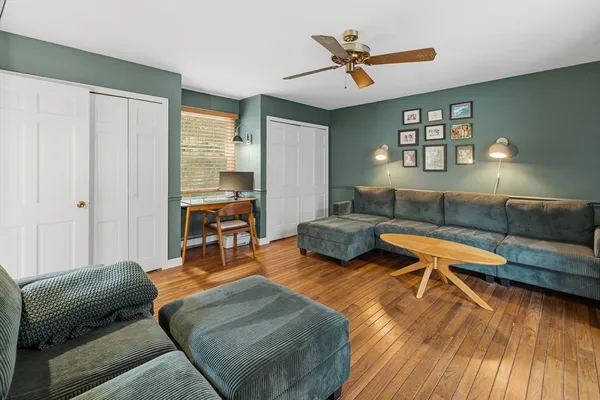 a living room with furniture and wooden floor