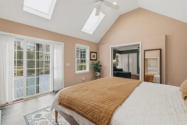 a bedroom with a large bed and a large window