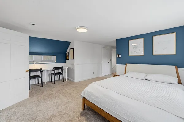 a bedroom with a bed and a chair