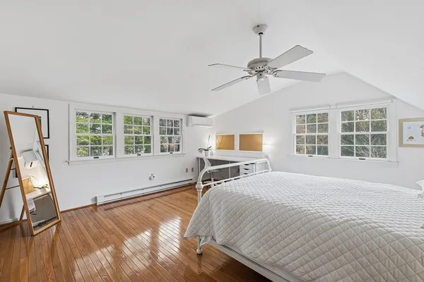 a bedroom with a bed and a large window