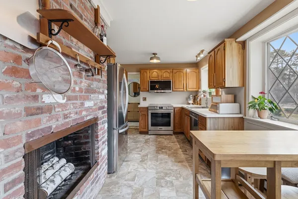 a kitchen with a stove a sink and a microwave