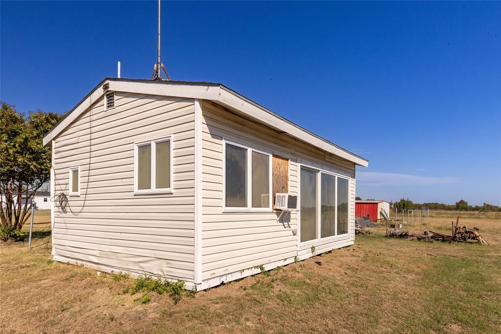 9119 Whiskers Road Quinlan, TX 75474 - Photo 3 of 12 a front view of a house