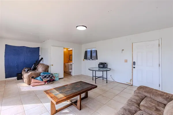 a living room with furniture a window and a lamp