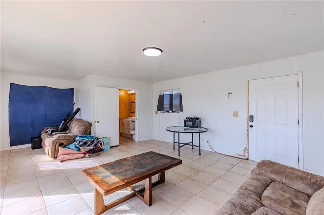 a living room with furniture a window and a lamp