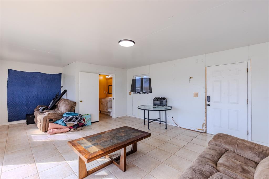 9119 Whiskers Road Quinlan, TX 75474 - Photo 6 of 12 a living room with furniture a window and a lamp