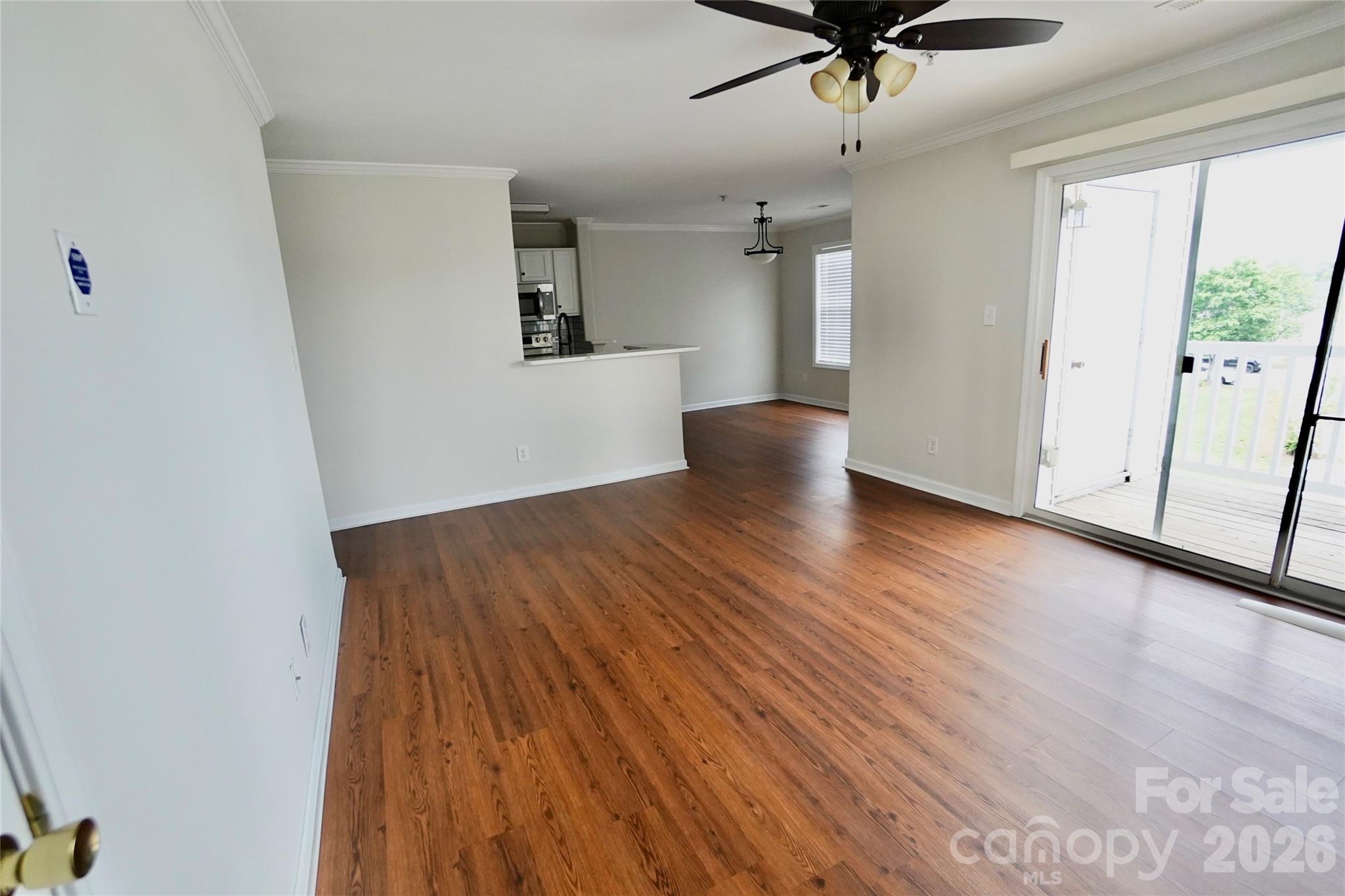 4010 Town Center Road Harrisburg, NC 28075 - Photo 2 of 17 wooden floor in an empty room with a window