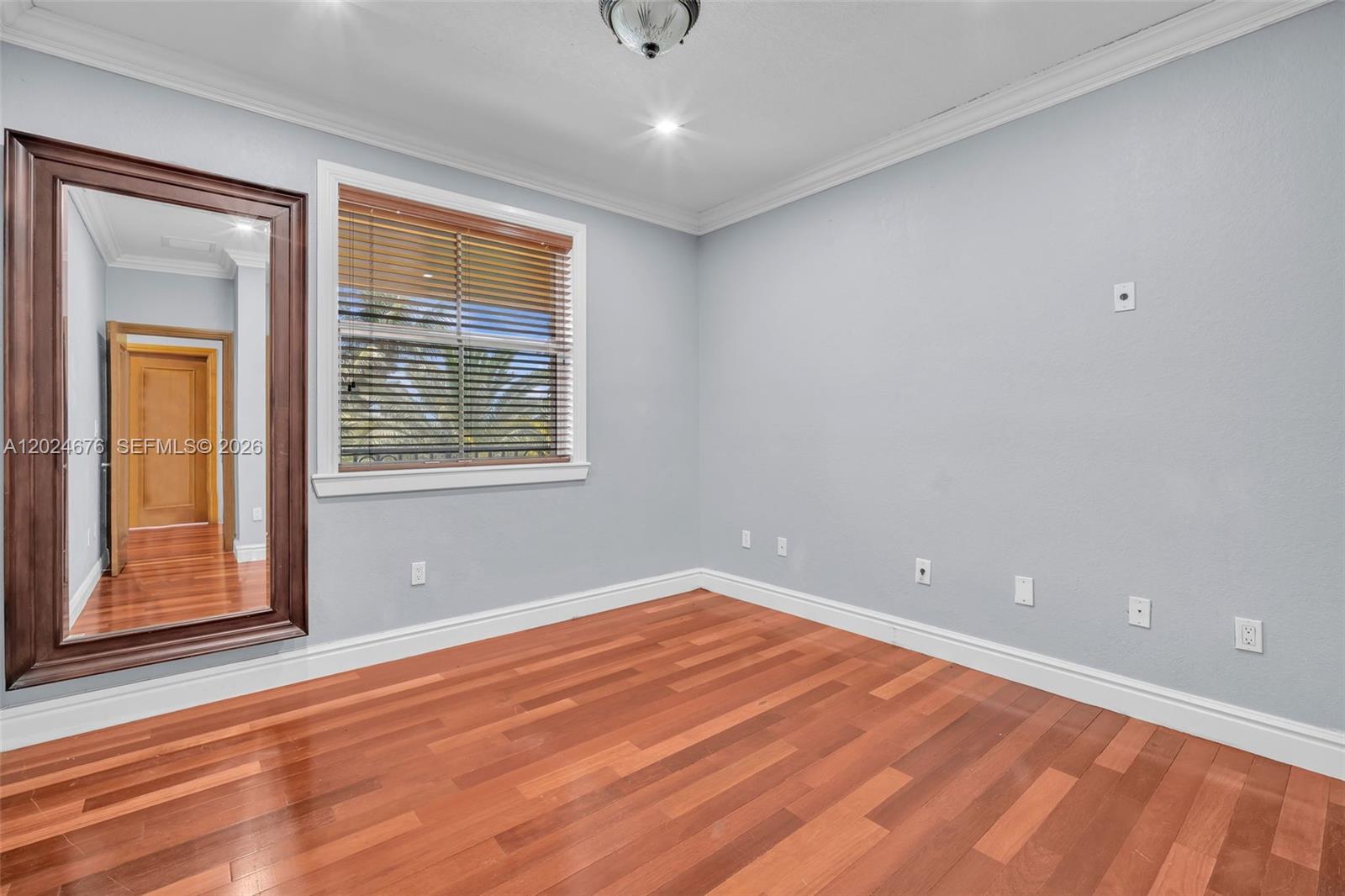 2155 Southwest 156th Court Miami, FL 33185 - Photo 50 of 57 a view of an empty room with wooden floor and a window