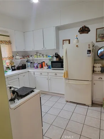a kitchen with a sink a cabinetry and appliances
