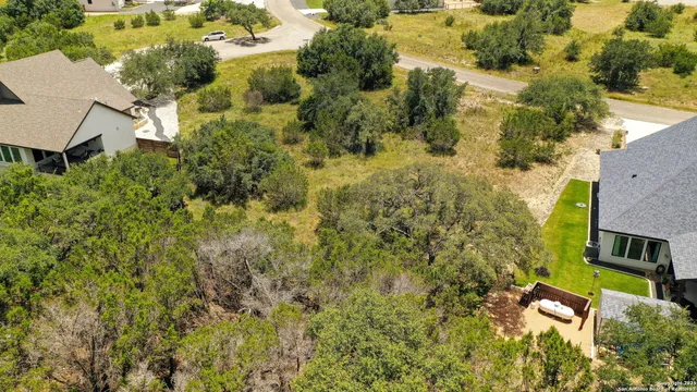 an aerial view of a house with a yard