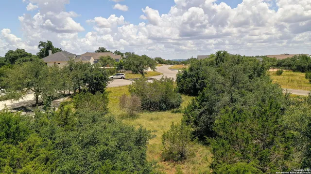 a view of a lake with houses in back