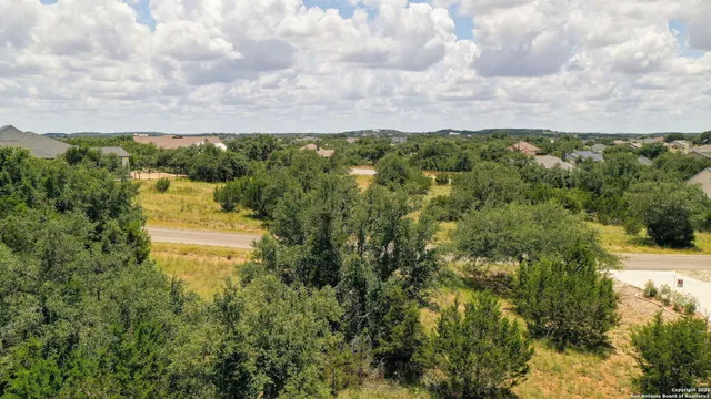 a aerial view of a houses with yard