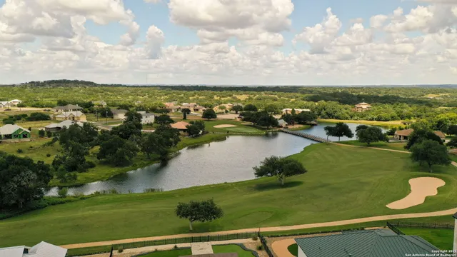 an aerial view of residential houses with outdoor space and swimming pool