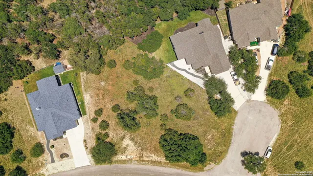an aerial view of a house with a yard