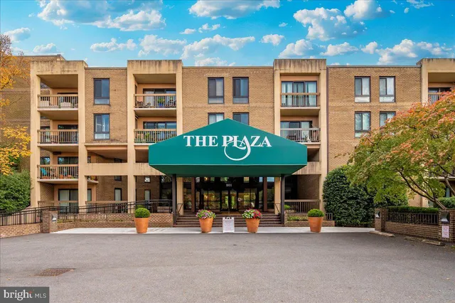 a view of a cafe with a table and chairs under an umbrella