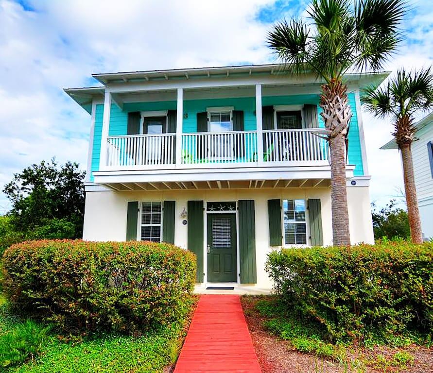 198 Somerset Bridge Road, Unit 129 Santa Rosa Beach, FL 32459 - Photo 1 of 19 a front view of a house with a garden