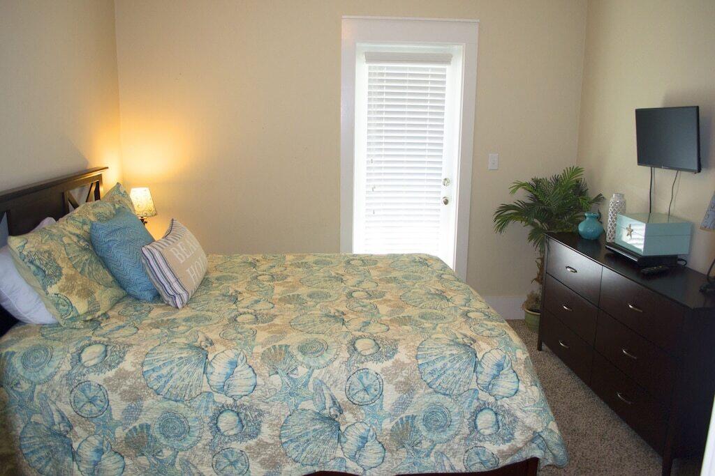 198 Somerset Bridge Road, Unit 129 Santa Rosa Beach, FL 32459 - Photo 13 of 19 a bedroom with a bed and a flat tv screen on dresser