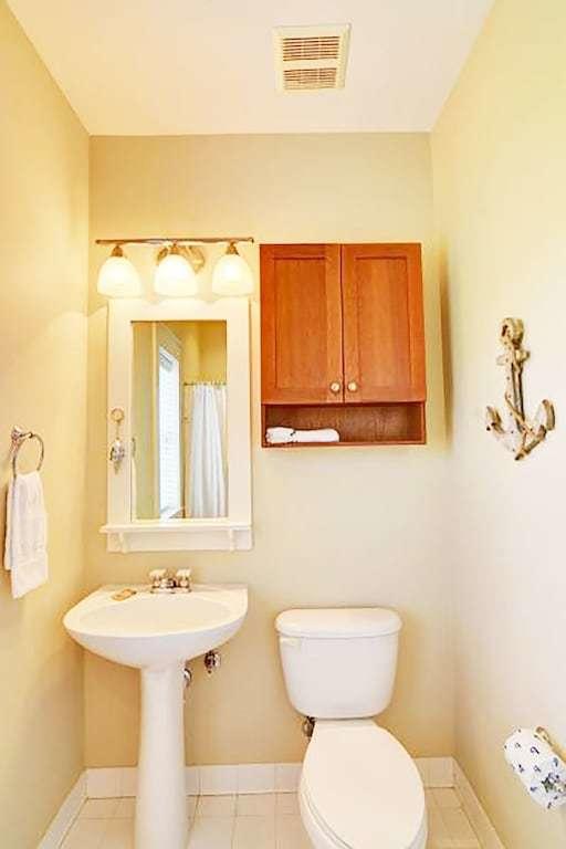 198 Somerset Bridge Road, Unit 129 Santa Rosa Beach, FL 32459 - Photo 16 of 19 a bathroom with a toilet a sink and a mirror