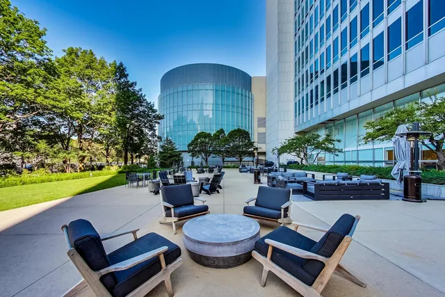 a view of a patio with swimming pool and sitting area