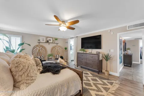 a view of a swimming pool with a lawn chairs and palm tree