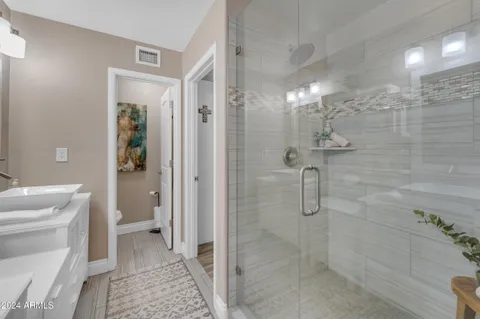 a view of a swimming pool with lawn chairs under an umbrella