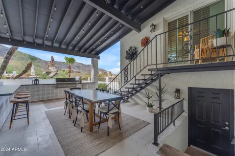a living room with stainless steel appliances kitchen island granite countertop furniture and a large window