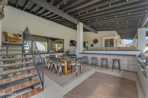 a living room with furniture and kitchen view
