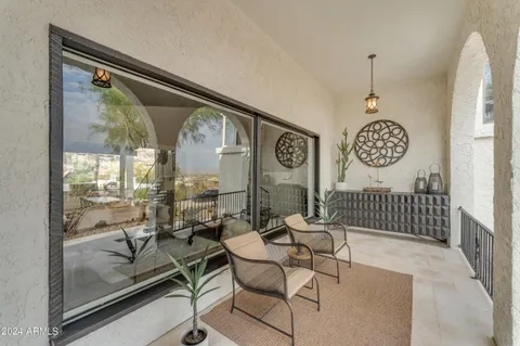 a kitchen with a sink and chairs