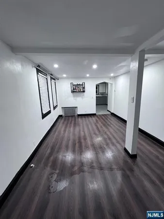 a view of a room with wooden floor and stairs