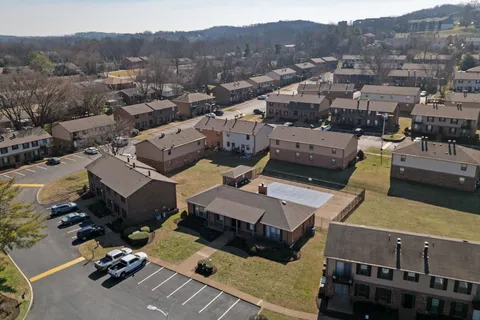 an aerial view of a house with a mountain