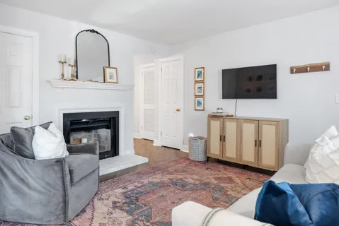 a living room with furniture and a fireplace